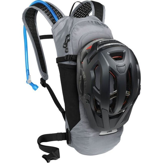 Camelbak Lobo 9 Hydration Pack 70oz, Gunmetal, View with a helmet secured to the backpack