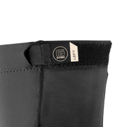 Close-up of a black wetsuit with a brand label on a white background