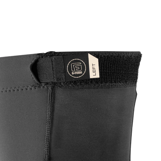 Close-up of a black wetsuit with a brand label on a white background