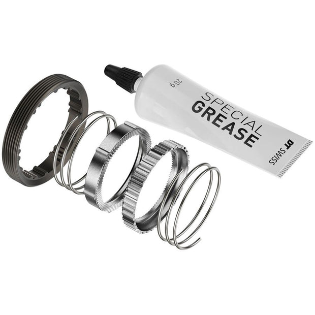Metallic gaskets and a tube of special grease on a white background