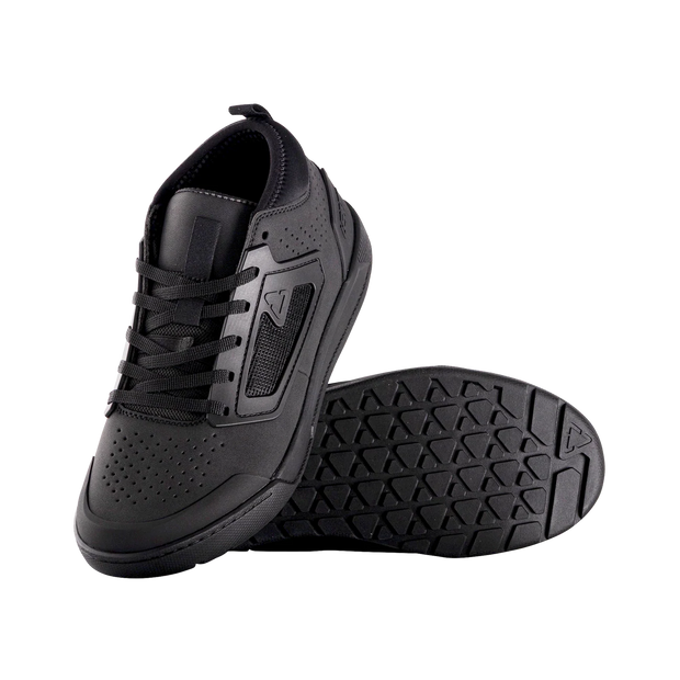 Black athletic shoe with textured sole on a white background