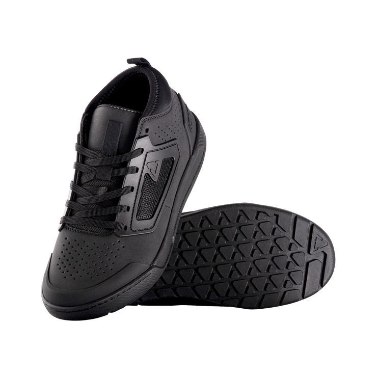 Black athletic shoe with textured sole on a white background