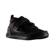 Black athletic shoe with velcro straps on a white background