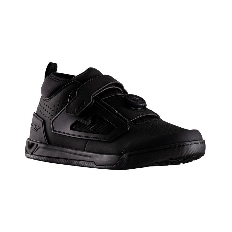 Black athletic shoe with velcro straps on a white background