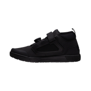 Black high-top sneaker with velcro straps on a white background