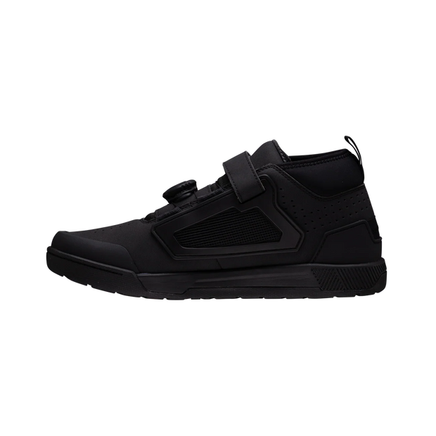 Black high-top sneaker with velcro straps on a white background