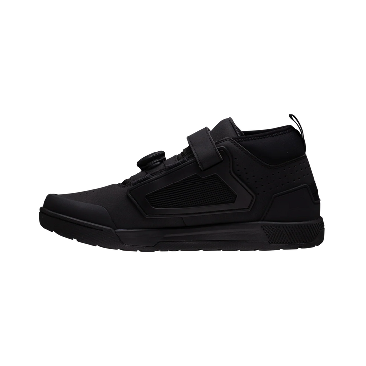 Black high-top sneaker with velcro straps on a white background