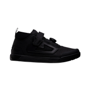 Black high-top sneaker with velcro straps on a white background