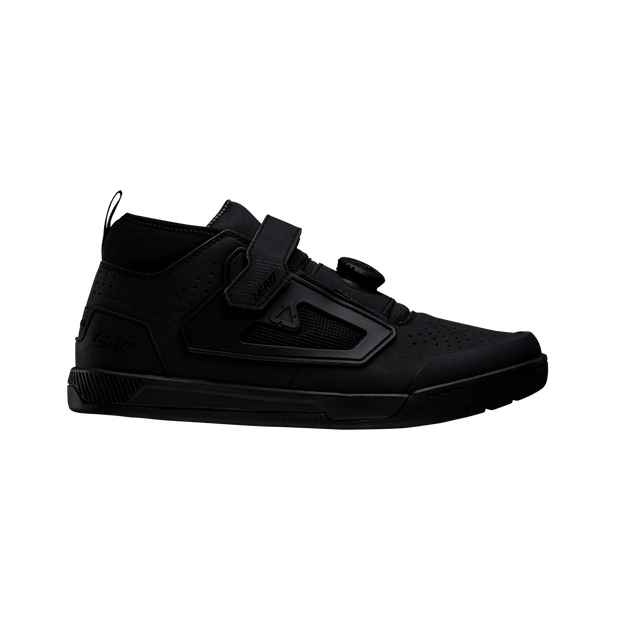 Black high-top sneaker with velcro straps on a white background
