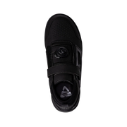 Black shoe with velcro strap on a white background