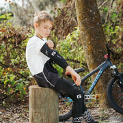 Boy putting on G-Form Youth Pro-X4 Knee and elbow pads