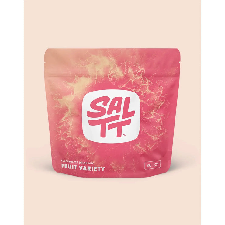 Pink package of SALTT fruit variety electronic drink mix on a beige background
