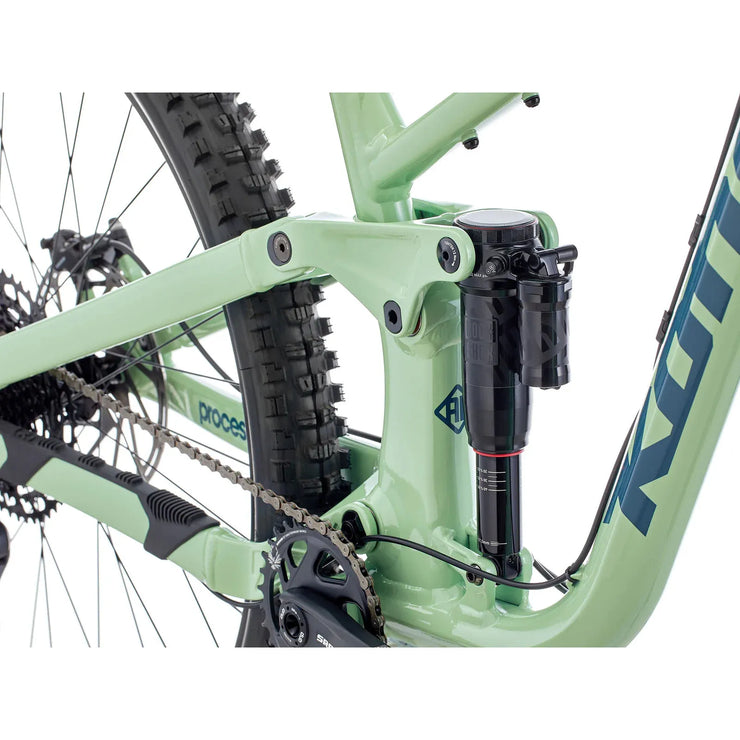 2024 Kona Process 153 DL, Gloss Jade w/ Strom Blue Decals, shock close-up view.