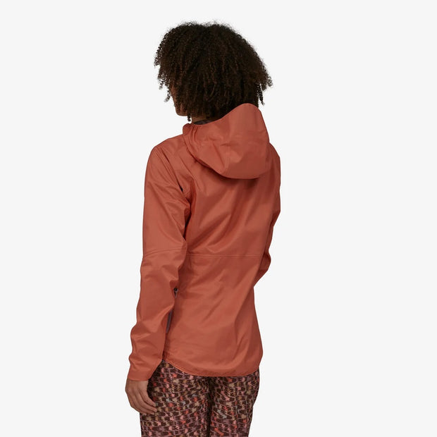 Patagonia Women's Dirt Roamer Jacket, quarts coral, back view on model.