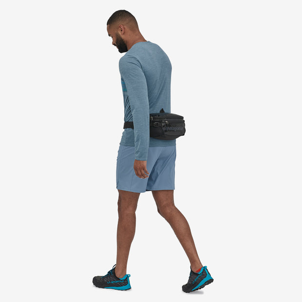 Patagonia Black Hole Waist Pack 5L, black, back view on model.