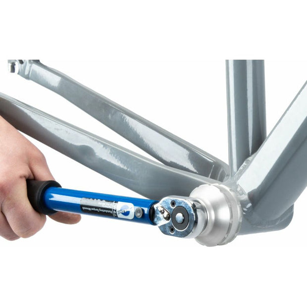 Park Tool BBT-79.3 Bottom Bracket Tool - 12-Notch, Silver. Model using a torque wrench on the bottom bracket tool view. 