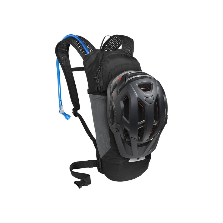 Camelbak Lobo 9 Hydration Pack 70oz, Black, View with a helmet secured to the backpack