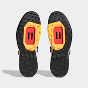 Five Ten Trailcross Clip-In Men's Mountain Bike Shoe, Solar Gold / Core Black/ Impact Orange, underside view of pair.