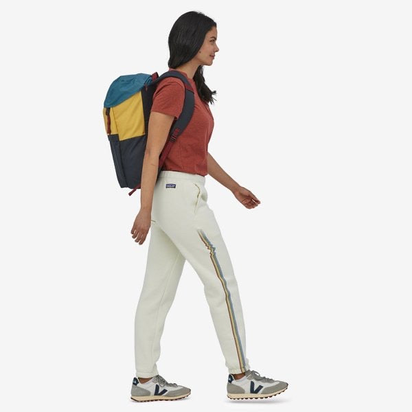 Patagonia Arbor Lid Pack 28L in color: patchwork pitch blue, side view on model.