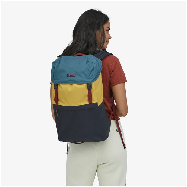 Patagonia Arbor Lid Pack 28L in color: patchwork pitch blue, full view on model.